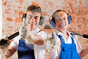 Friendly construction workers with thumps up