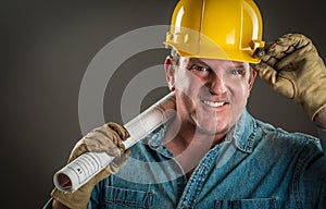 Friendly Contractor in Hard Hat Holding Floor Plans