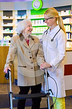 Friendly doctor with patient using walker