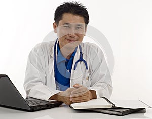 Friendly Doctor sitting at his desk