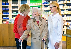 Friendly doctor talking with two elderly women