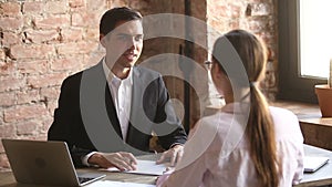 Friendly employer handshaking welcoming hired employee after successful job interview