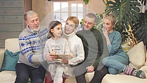 Friendly extended family watching photos from tablet