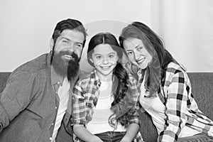 Friendly family sit couch posing for photo family album. Mom dad and daughter relaxing on couch. Close and trustful