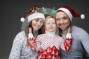 Friendly family of three standing together and smiling