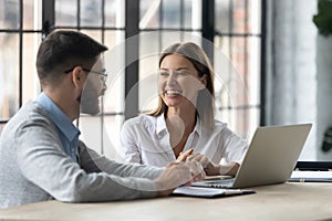 Bank worker with customer sitting at desk in office