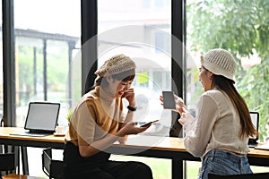 Friendly female colleagues having good relationships pleasant conversation.