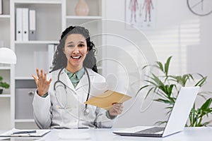 Friendly female doctor explaining with enthusiasm in clinic office