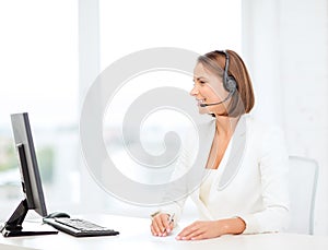 Friendly female helpline operator with computer