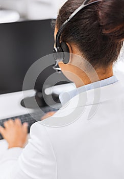 Friendly female helpline operator with headphones