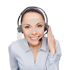 Friendly female helpline operator with headphones