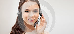 Friendly female helpline operator with headphones