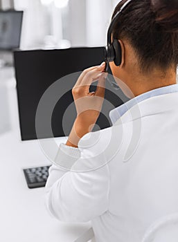 Friendly female helpline operator with headphones