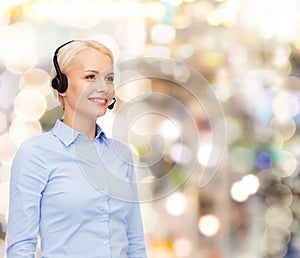 Friendly female helpline operator with headphones