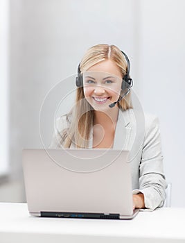 Friendly female helpline operator with laptop
