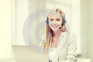 Friendly female helpline operator with laptop