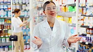 Friendly female pharmacist invites you to visit pharmacy or a store of healing cosmetics