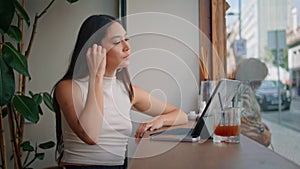 Friendly girl greeting web camera laptop starting video call in cafe close up.