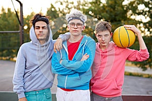 Friendly group of caucasian teenagers boys ready to play basketball