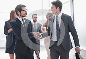 Friendly handshake of business people in the office