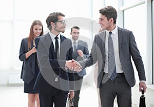 Friendly handshake of business people in the office