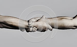 Friendly handshake, friends greeting, teamwork, friendship. Close-up. Rescue, helping gesture or hands. Strong hold. Two