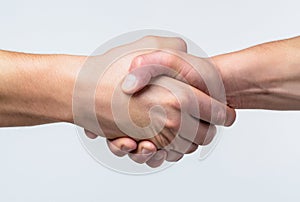 Friendly handshake, friends greeting, teamwork, friendship. Close-up. Rescue, helping gesture or hands. Strong hold. Two