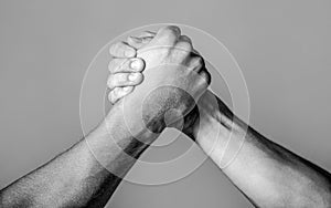 Friendly handshake, friends greeting, teamwork, friendship. Handshake, arms, friendship. Hand rivalry vs challenge