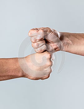 Friendly handshake, friends greeting. Two hands, isolated arm. Man giving fist bump. Team concept. People bumping their