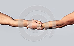 A friendly handshake. Two hands, shaking hands. Two hands, helping arm of a friend, teamwork. Rescue, helping gesture or