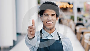 Friendly happy african american male worker waiter salesman in apron man shows good perfect sign with hand small