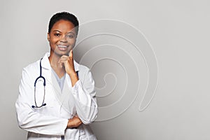 Friendly happy doctor woman medical worker in lab coat on white background