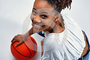 Friendly happy young Black woman smiling up at the camera