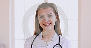 Friendly happy young female doctor physician smiling face closeup portrait