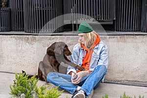 Friendly homeless dog sitting with guy in downtown begging food giving paw.