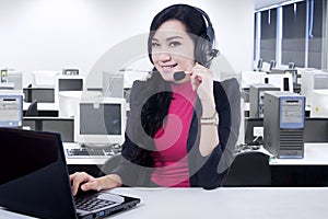 Friendly hotline operator with laptop