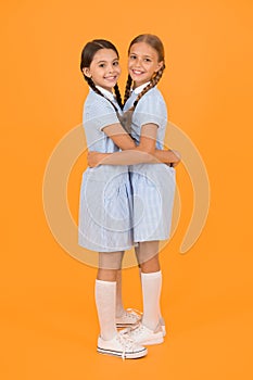 Friendly hug. Beautiful schoolgirls best friends. Back to school concept. Cute schoolgirls. Girls braided hairstyle