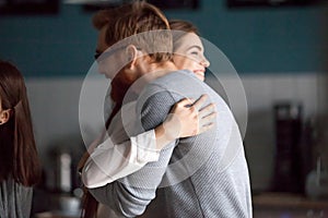 Friendly hug concept, smiling millennial man and woman embracing