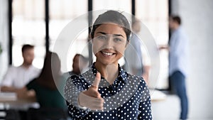 Friendly indian boss greeting client stretch out hand for handshake