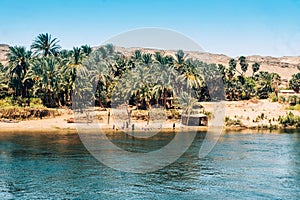 Friendly Locals Waving from Nile Shore to Cruise Ship. Egypt Summer Travel