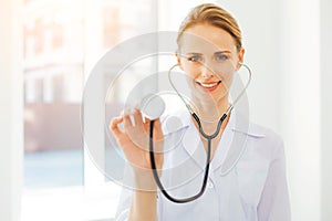 Friendly looking female practitioner posing with stethoscope