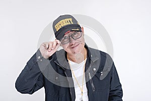 A friendly male security guard tips his cap as acknowledgment or as a greeting. Isolated on a white background