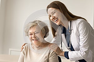 Friendly medical professional give care and support to elderly person photo