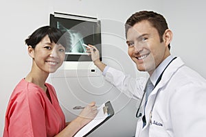 Friendly Medical Staff Members With X-Ray Results