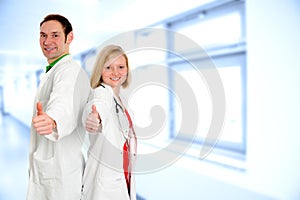 Friendly medical team in lab coat with thumbs up