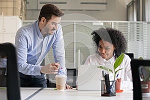 Friendly mentor explaining task African American employee photo