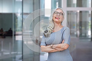 Friendly middle aged business female leader laughing, happy old businesswoman enjoying smiling, mature business coach and executiv