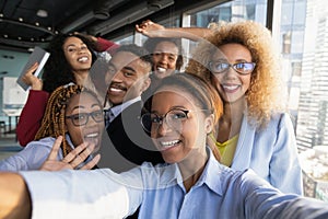 Friendly millennial black business team take funny group office selfie