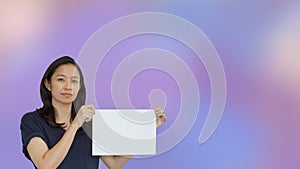 Friendly mixed race casual Asian mature woman presenting gesture with copy space for advertising