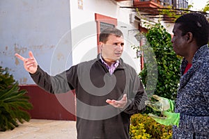 Friendly neighbors discuss on the farm in village